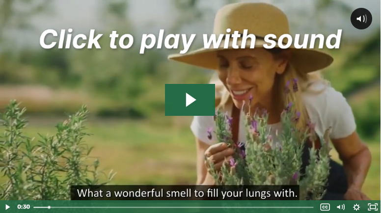 a woman smelling medicinal plants,  watch a video